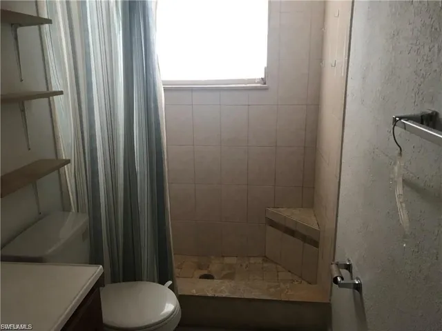 Full bathroom featuring a stall shower and vanity