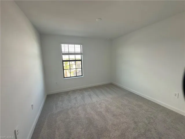 Unfurnished room with carpet flooring