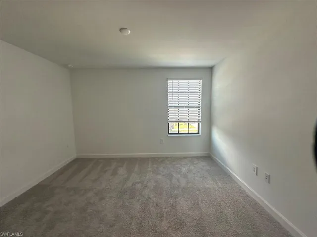 Unfurnished room featuring carpet