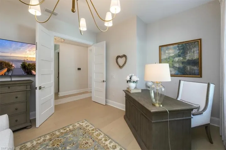 Office featuring light wood finished floors and suspended lighting