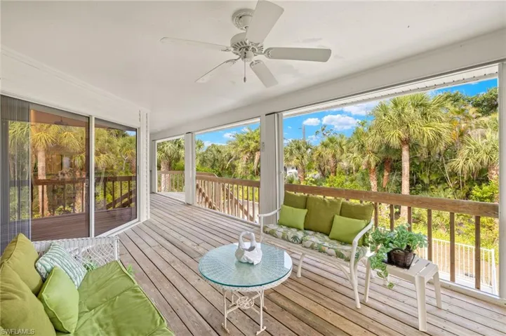 Sunroom / solarium with ceiling fan and outdoor lounge area