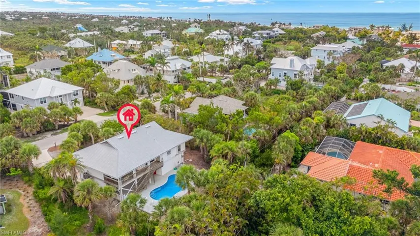 Aerial perspective of suburban area featuring a large body of water and a pool