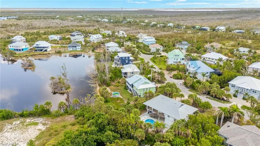 Aerial perspective of suburban area with a nearby body of water