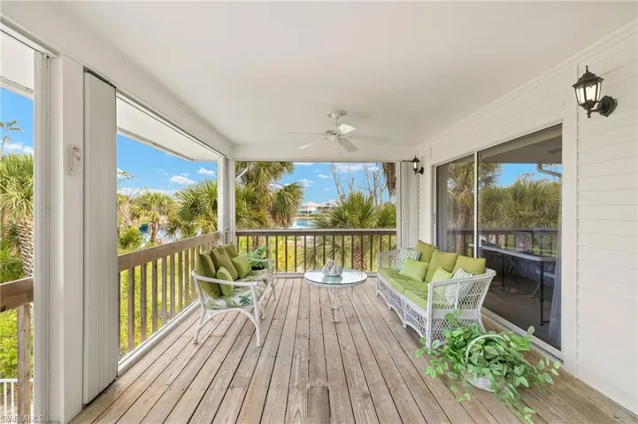 Wooden deck with ceiling fan and an outdoor hangout area