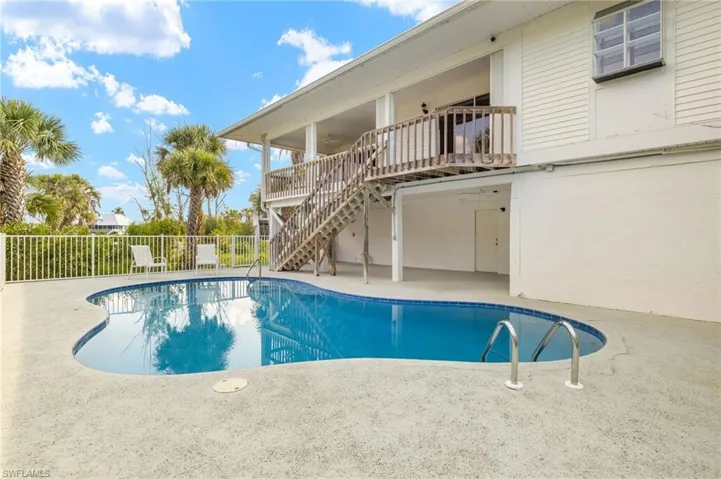 View of swimming pool featuring stairs and a patio