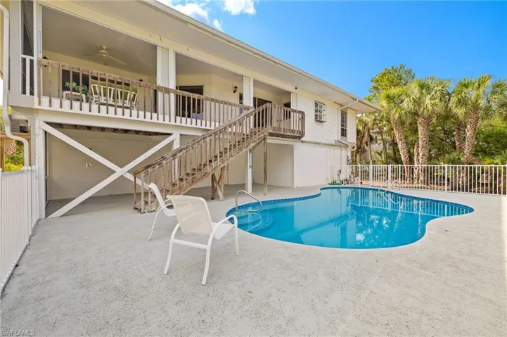 View of pool with stairs and a patio area