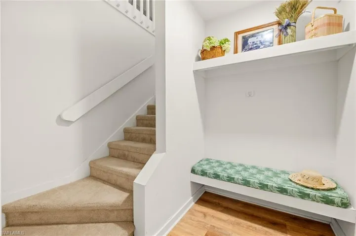 Mudroom with wood finished floors and baseboards