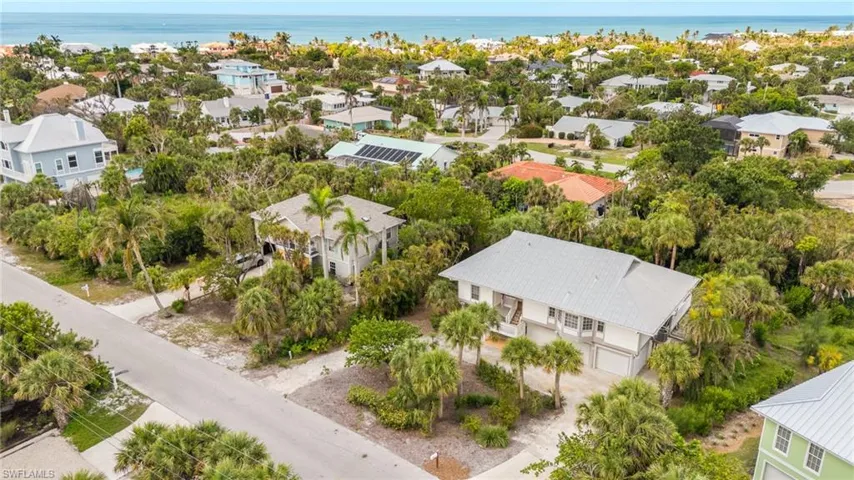 Aerial view of residential area featuring a large body of water