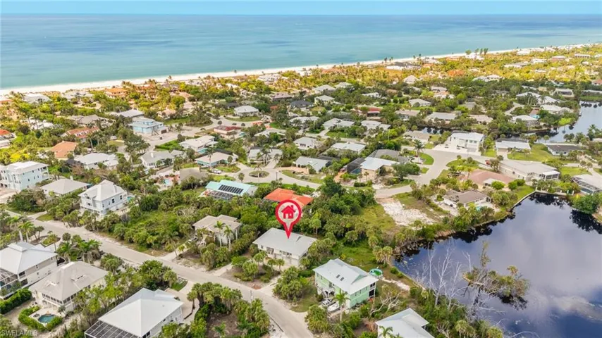 Aerial overview of property's location with a large body of water and nearby suburban area