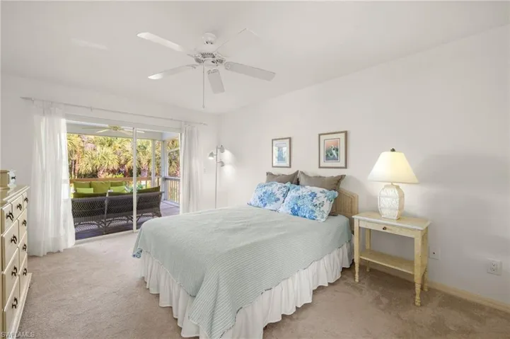 Bedroom with access to exterior, light carpet, and ceiling fan
