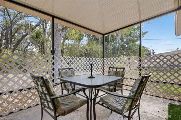 Sunroom / solarium with outdoor dining area
