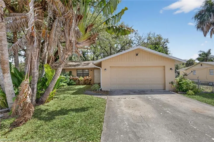View of front facade featuring concrete driveway, stucco siding, and an attached garage