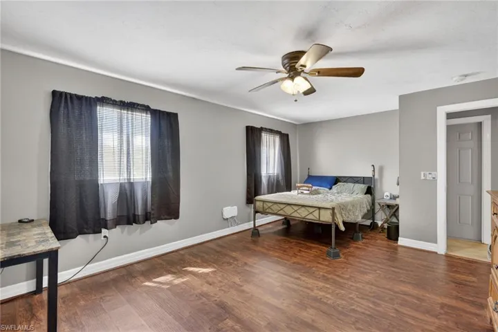 Bedroom featuring dark wood-style flooring and a ceiling fan