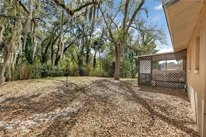 View of yard with a sunroom