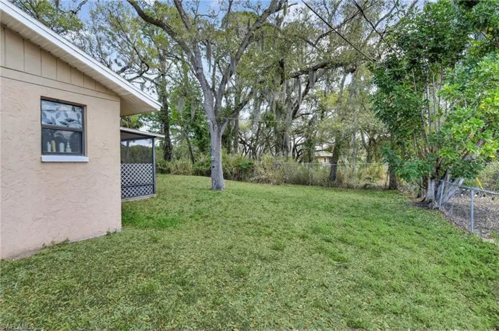 Fenced backyard with a sunroom