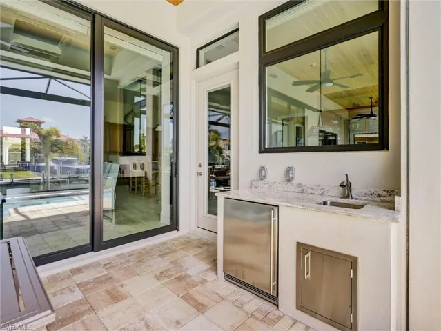 Convenient counter, "fridge" & storage for the lanai, beautifully finished  with granite