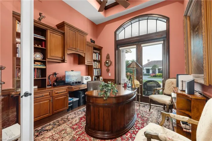 Office with ceiling fan, french doors, and built in desk