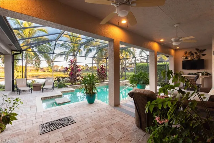 Pool with ceiling fans, water view