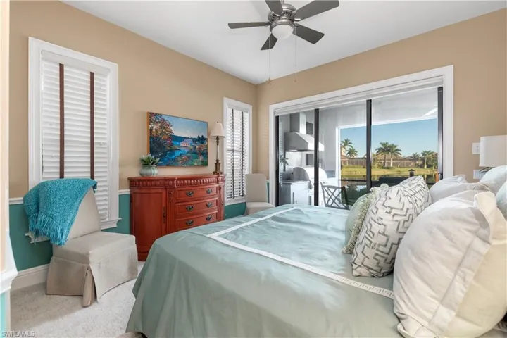 Carpeted bedroom featuring access to exterior and ceiling fan