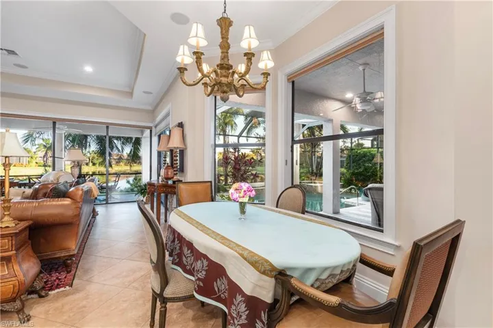 Eat in kitchen with crown molding and  light tile patterned flooring.