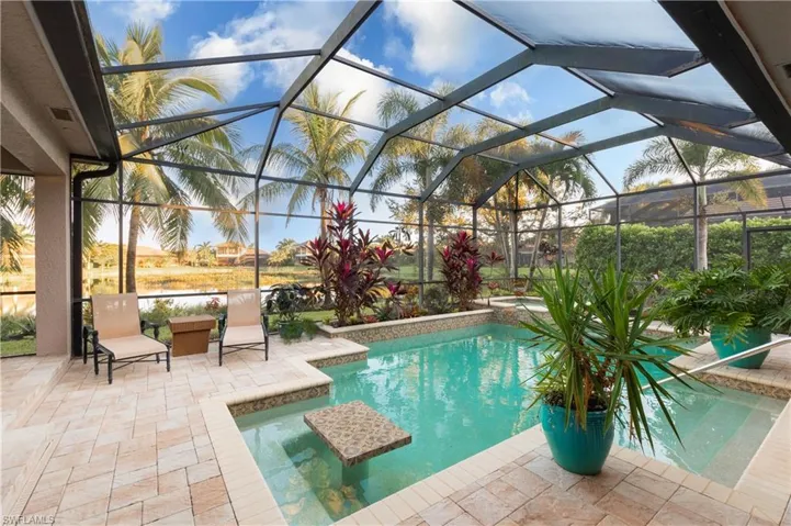 View of swimming pool with a patio area and a lanai