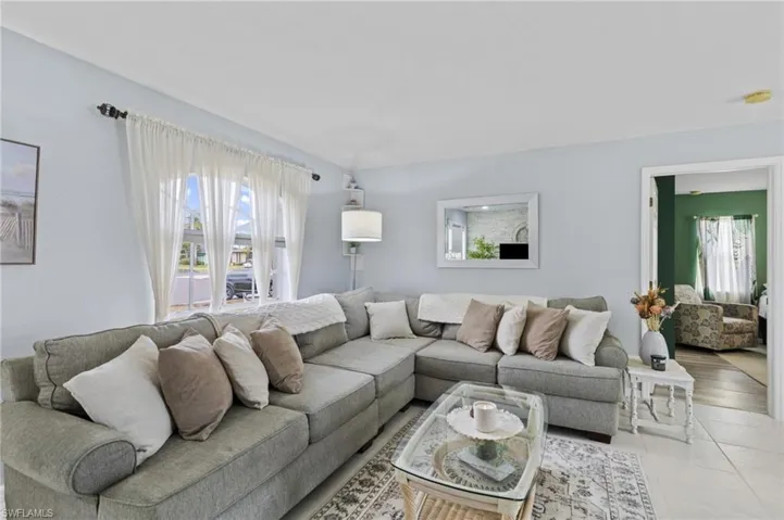 Living room with plenty of natural light and light tile patterned floors