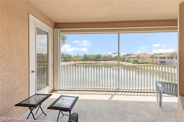 Unfurnished sunroom featuring a wealth of natural light, a textured wall, a textured ceiling, and a water view