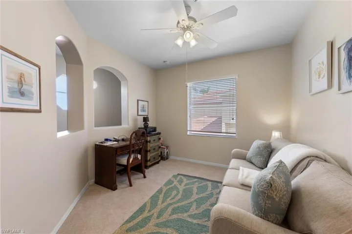 Office with ceiling fan, light carpet, and baseboards