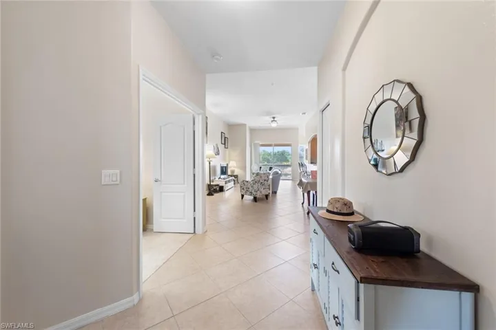 Hallway featuring baseboards and light tile patterned floors