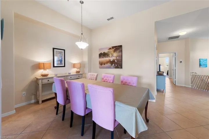 Dining space with baseboards, visible vents, and light tile patterned floors
