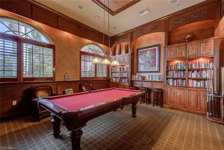 Game room featuring dark carpet, pool table, built in features, and visible vents