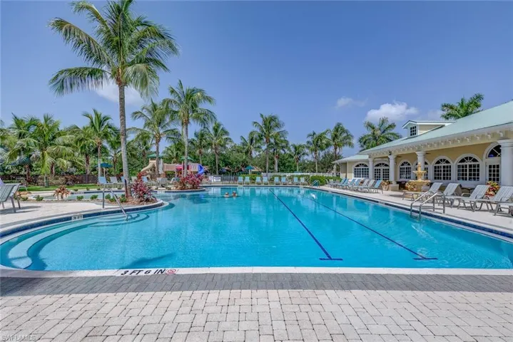 Community pool with fence and a patio area