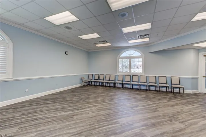 Spare room with baseboards, wood finished floors, and crown molding