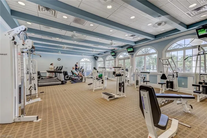 Exercise room featuring visible vents, recessed lighting, carpet flooring, and a healthy amount of sunlight