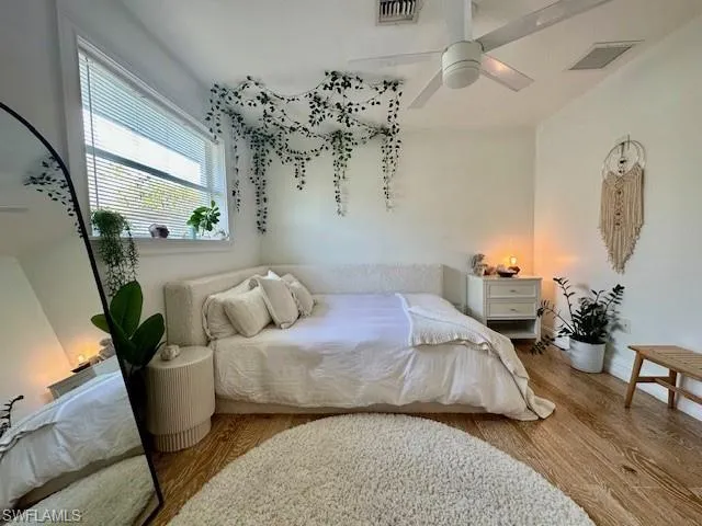 Bedroom with wood finished floors and ceiling fan