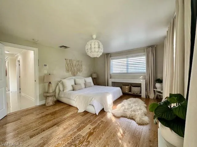 Master Bedroom with wood finished floors and baseboards