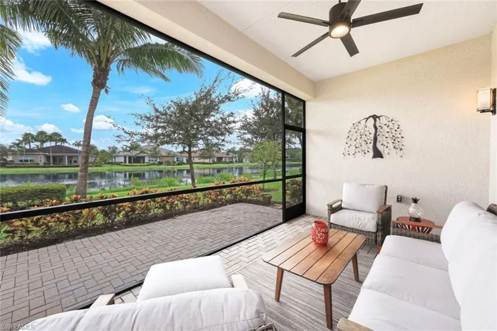 Sunroom / solarium with a water view and ceiling fan