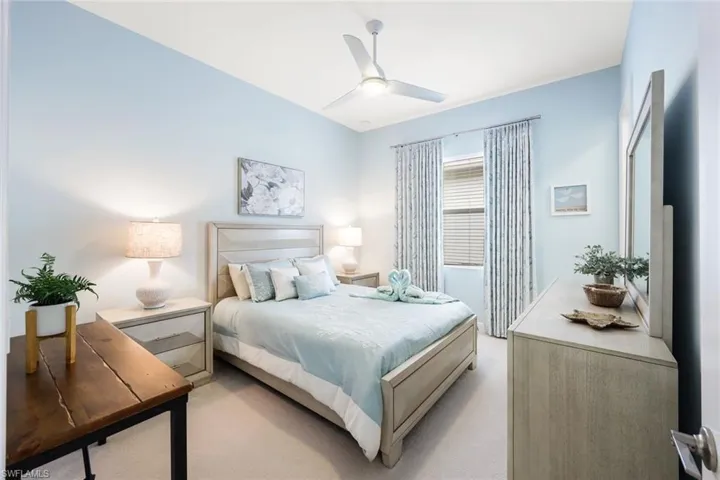 Bedroom featuring ceiling fan and light colored carpet