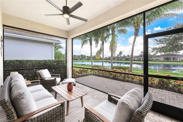 Sunroom / solarium featuring a water view and ceiling fan
