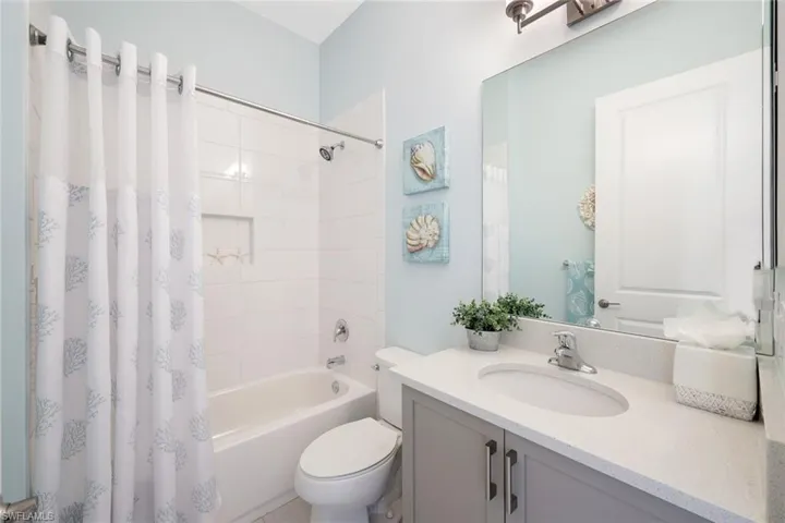 Full bathroom featuring shower / bath combo, vanity, and toilet