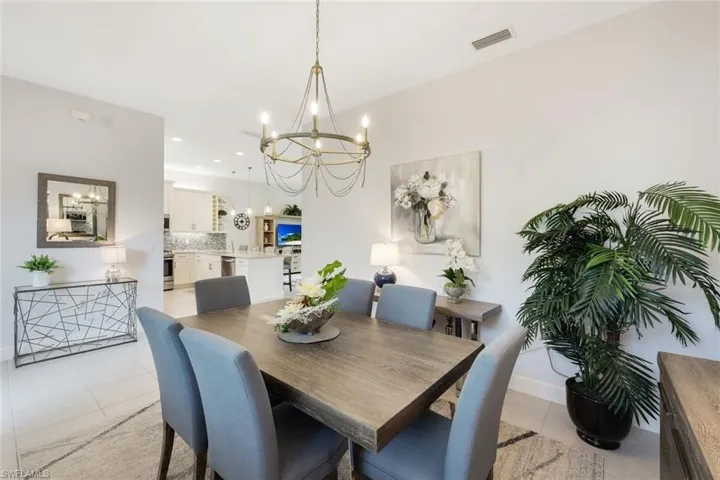 Tiled dining space with a notable chandelier