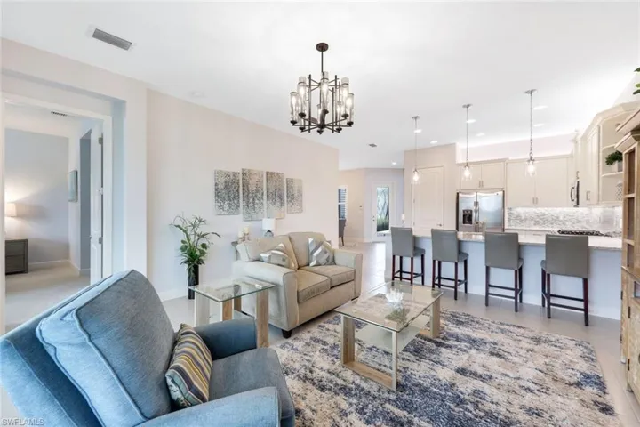 Tiled living room with a notable chandelier