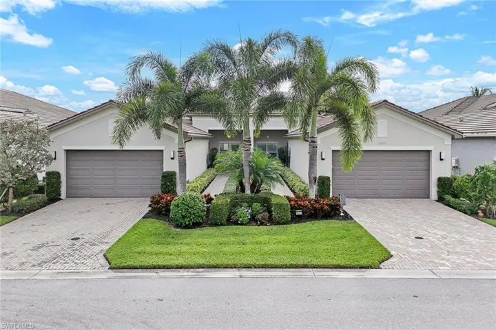 View of front of house with a front yard and a garage