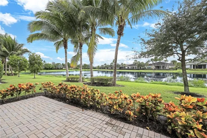 View of property's community with a water view and a yard