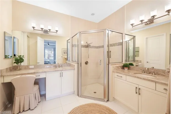 Bathroom featuring vanity, tile patterned flooring, and an enclosed shower