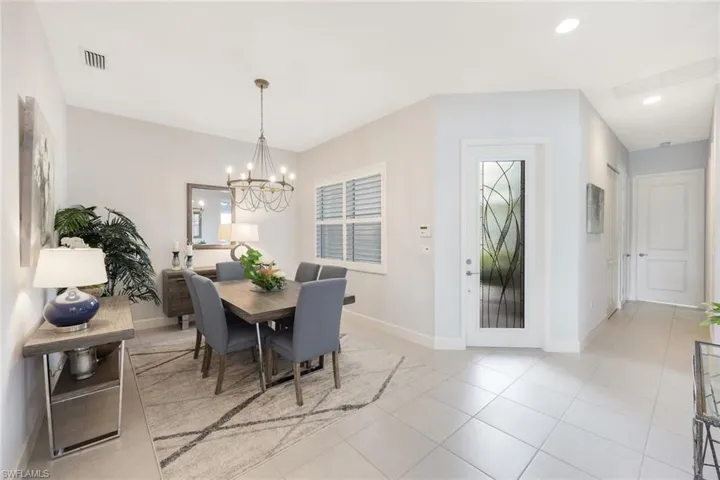 Tiled dining area with a chandelier