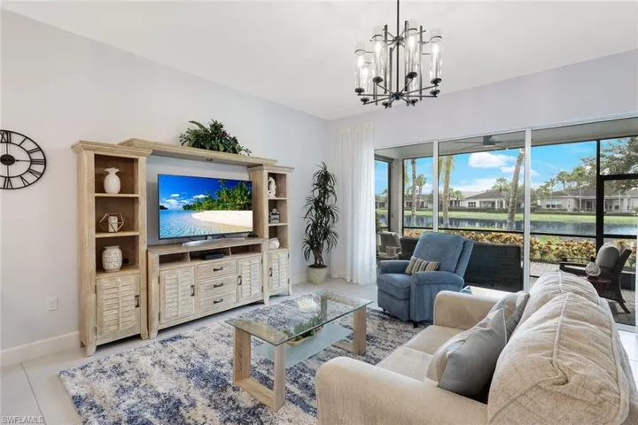 Tiled living room featuring a notable chandelier