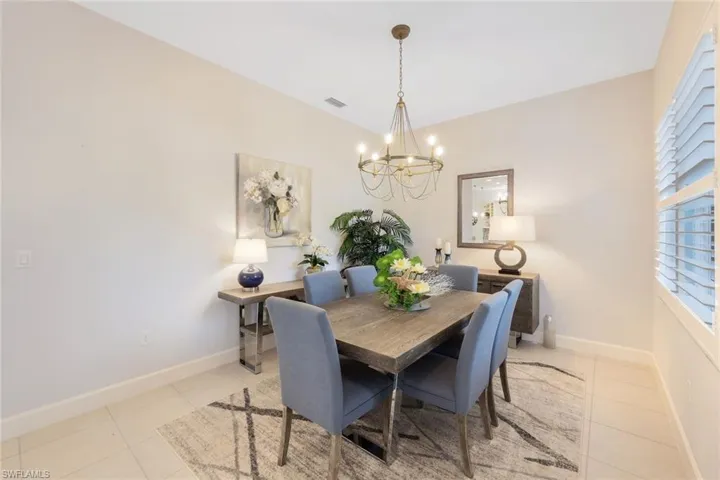 Tiled dining area with a chandelier