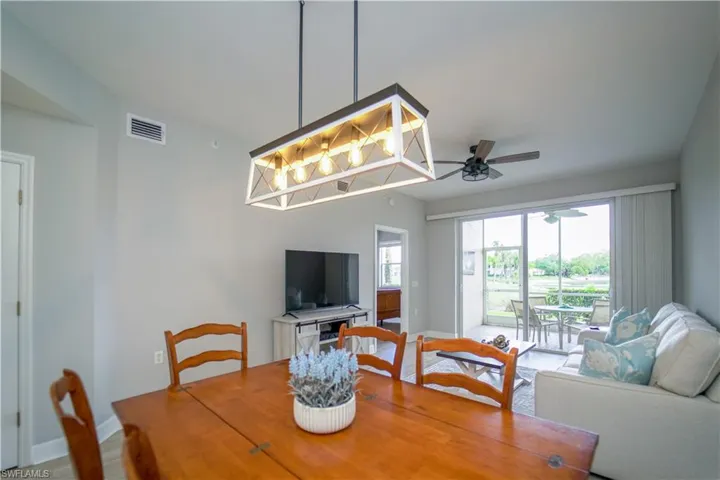 Dining room with a ceiling fan and light wood-type flooring