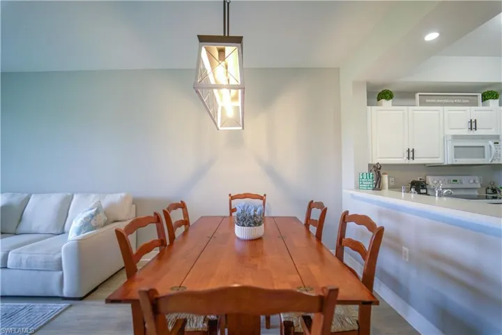 Dining area with recessed lighting and wood finished floors
